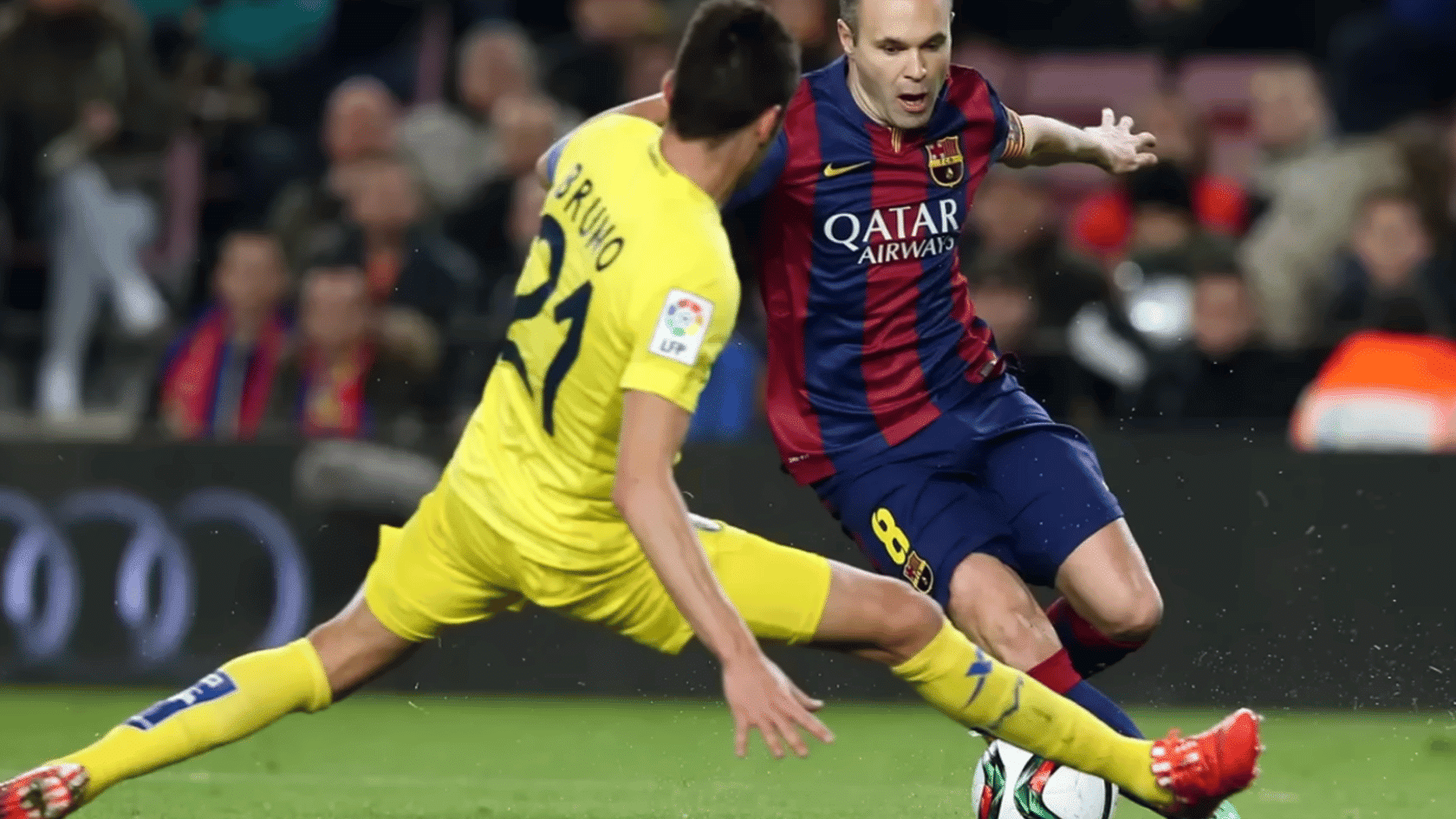 football midfielder dribbles past an opponent attempting a sliding tackle