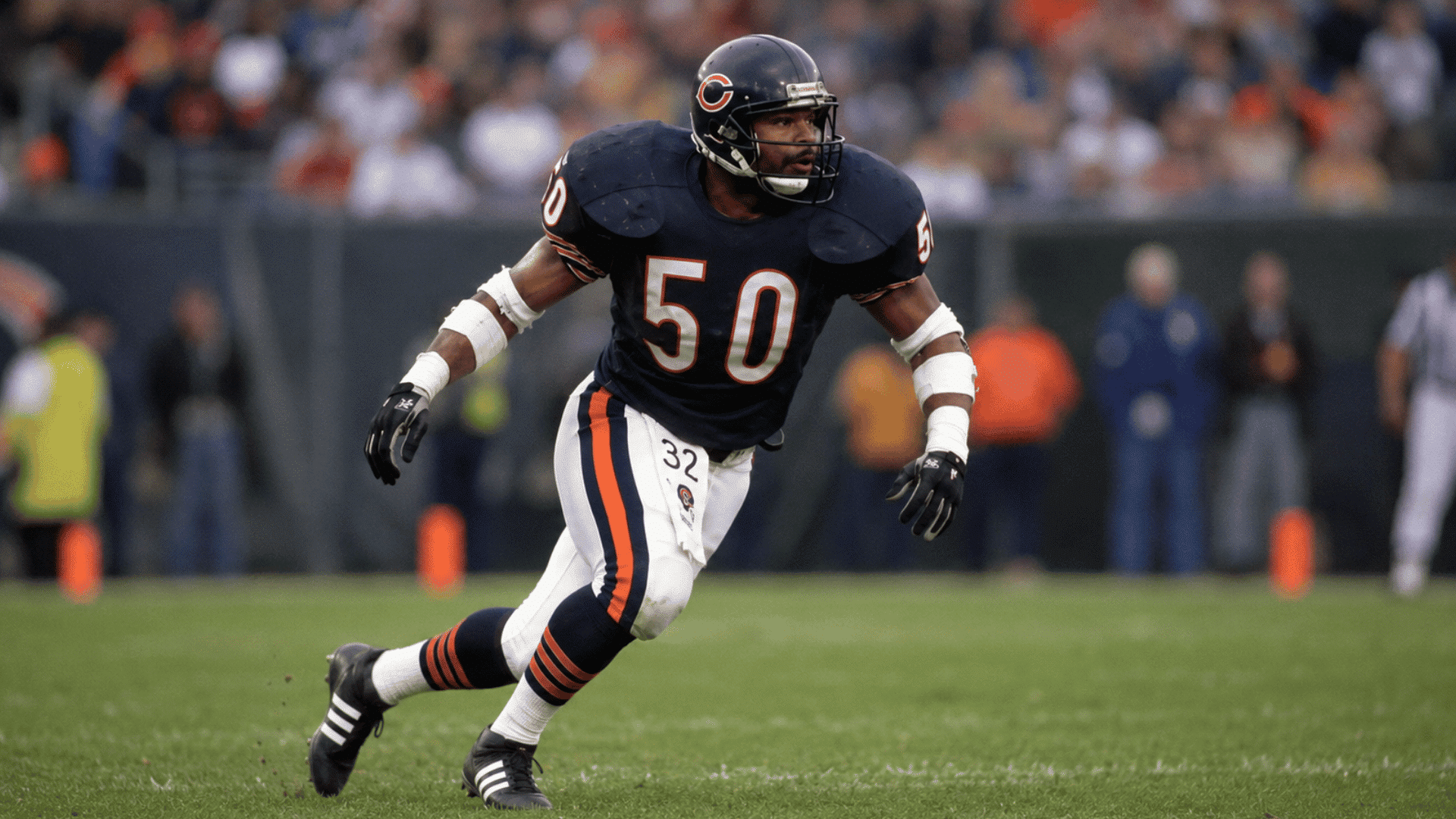 mike singletary moving across the field in a chicago bears uniform while tracking the play
