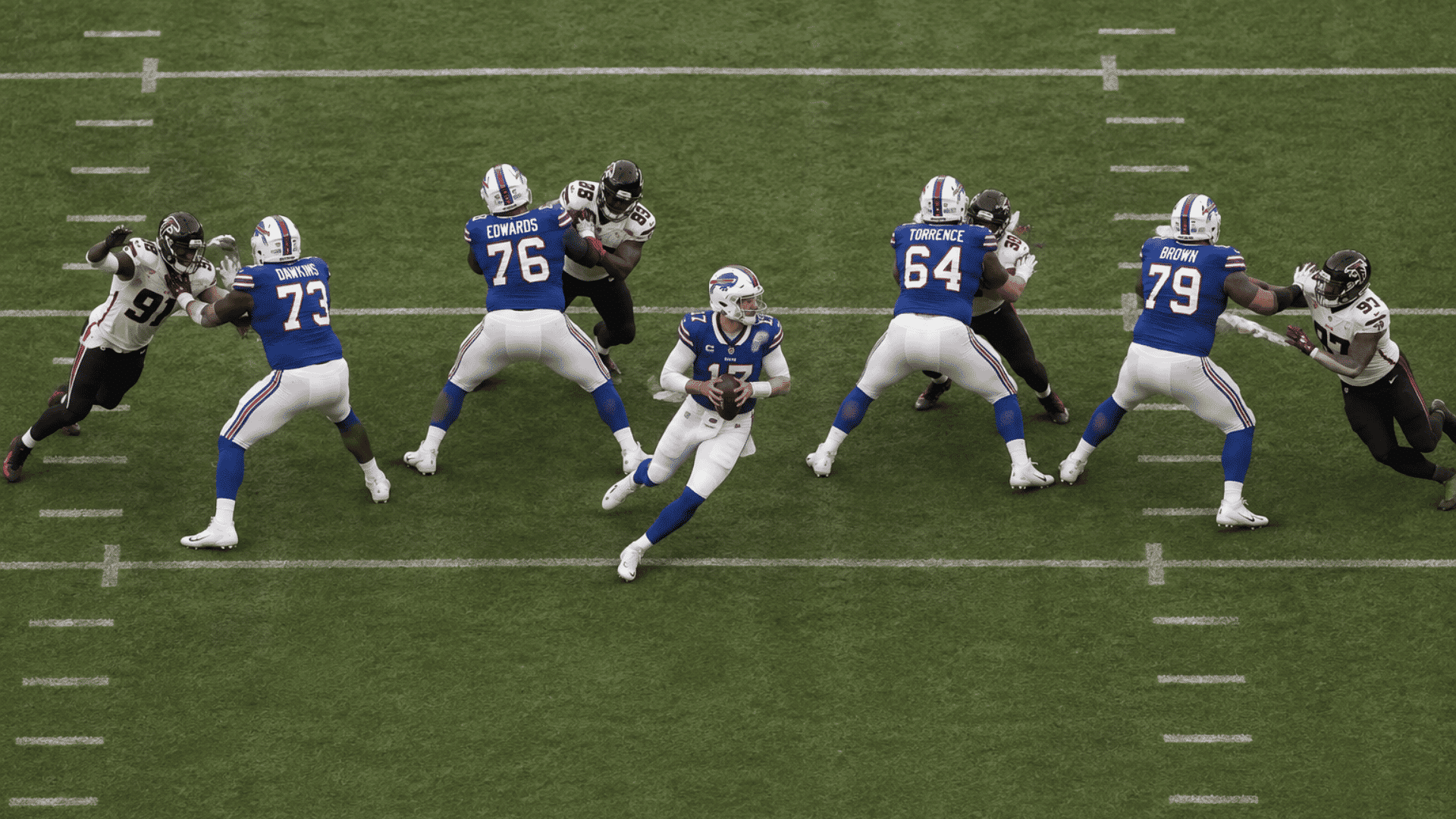 quarterback sliding inside the passing pocket while offensive linemen protect against edge rushers