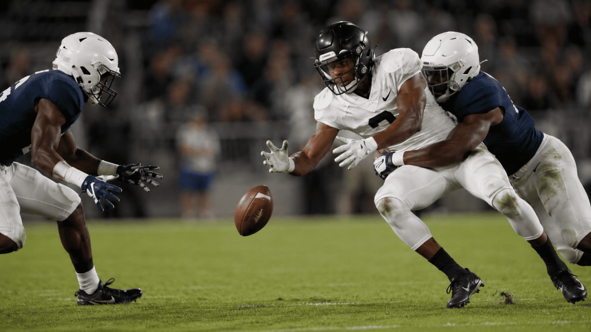 football players scramble for a loose ball during a fumble as defenders close in on the runner